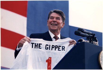 Photograph of President Reagan holding The Gipper jersey at 1984 campaign rally in New York - NARA - 198557