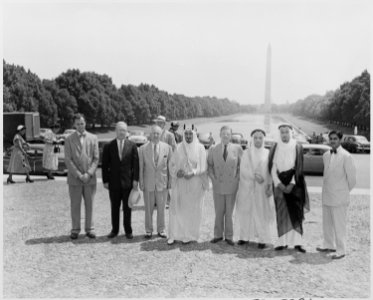 Photograph of Prince Faisal Al Saud of Saudi Arabia and his party standing in front of the Reflecting Pool and the... - NARA - 200386