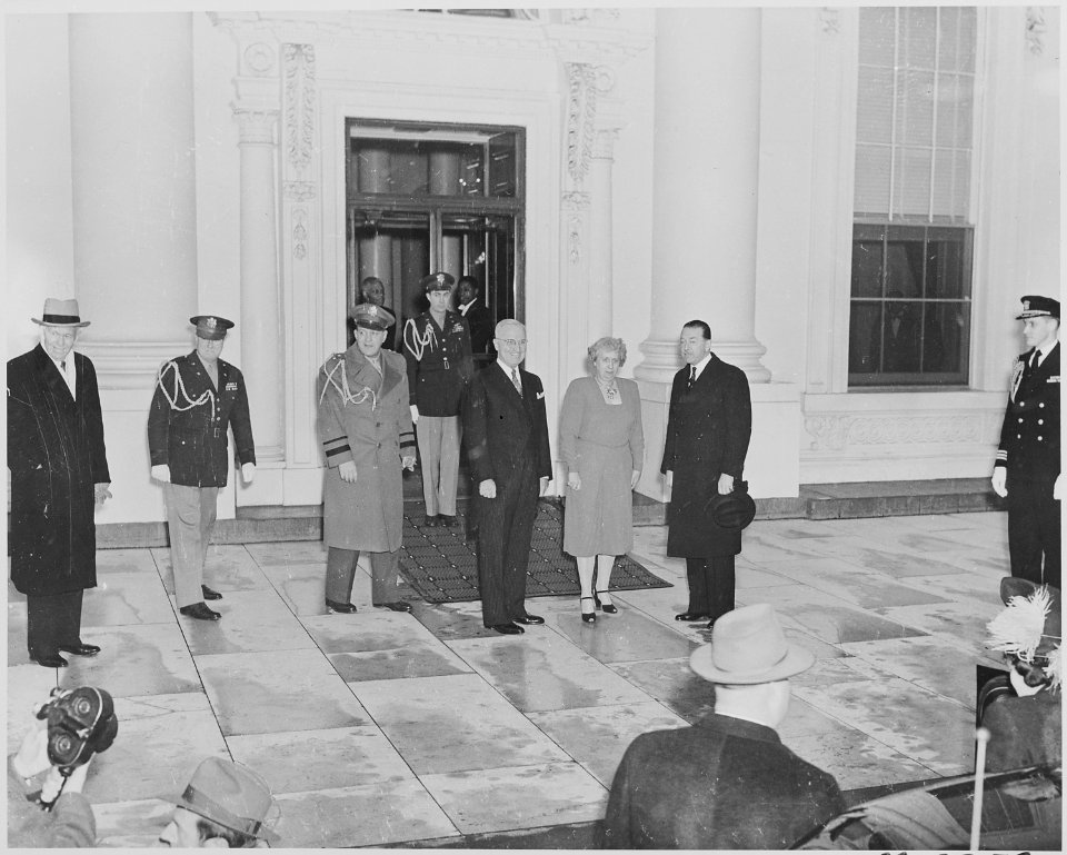 Photograph of President Truman and Mrs. Truman standing outside the White House. awaiting the arrival of Field... - NARA - 199514