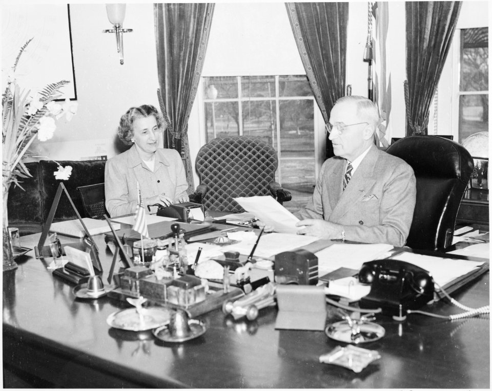 Photograph of President Truman at work at his desk in the Oval Office, dictating to his secretary, Rose Conway. - NARA - 199481