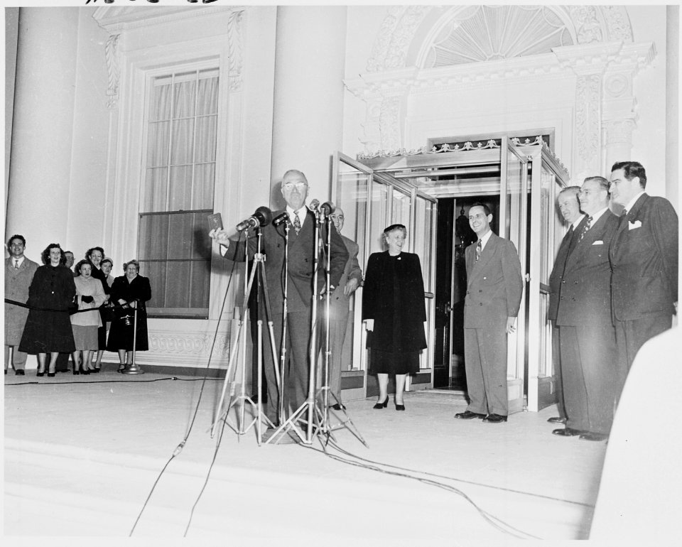 Photograph of President Truman holding up a gold key to the newly renovated White House, reopened to the First Family... - NARA - 200192
