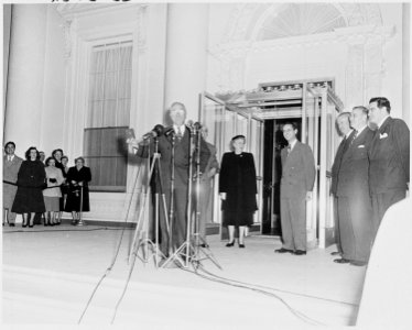 Photograph of President Truman holding up a gold key to the newly renovated White House, reopened to the First Family... - NARA - 200192 photo