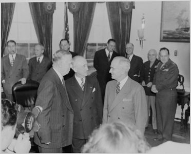 Photograph of President Truman in the Oval Office, talking with James Byrnes (the retiring Secretary of State) and... - NARA - 199515