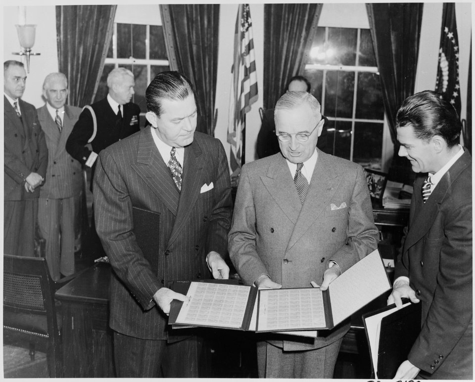 Photograph of President Truman receiving a set of stamps honoring the late President Franklin D. Roosevelt from... - NARA - 199345