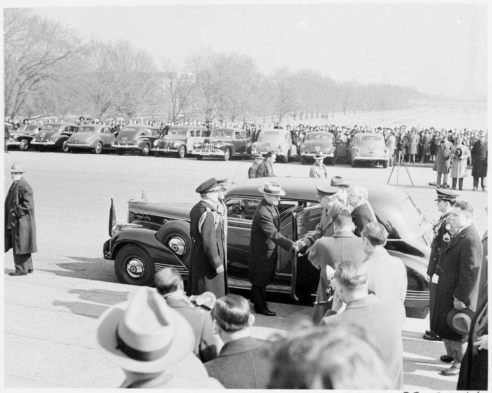 Photograph of President Truman shaking hands with an unidentified military officer beside his car at the Lincoln... - NARA - 199499