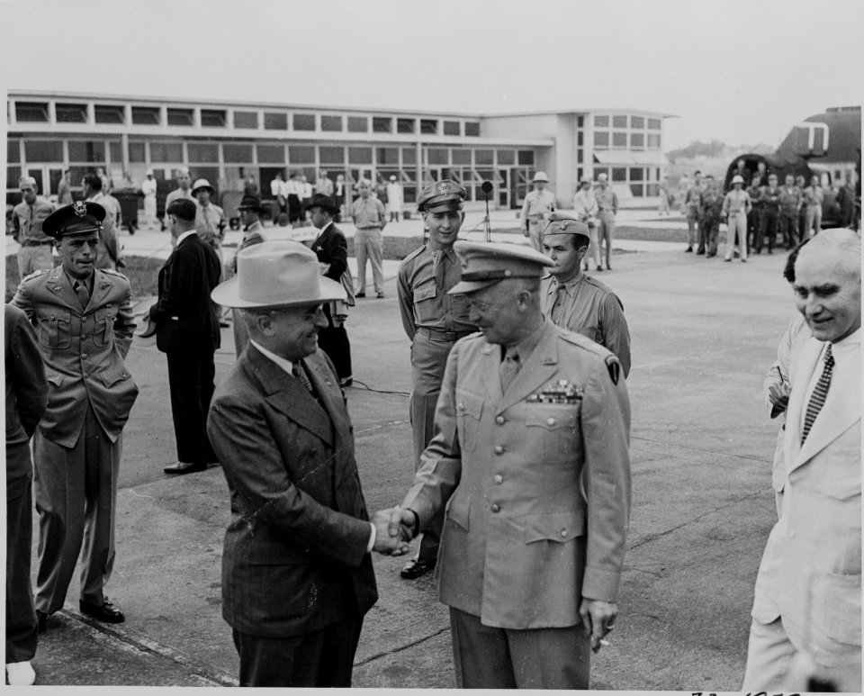 Photograph of President Truman shaking hands with General Dwight D. Eisenhower at the airport in Washington. - NARA - 199132