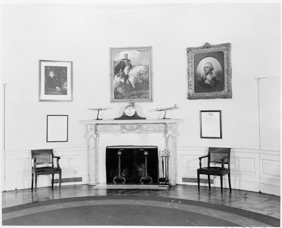 Photograph of the fireplace in the Oval Office of the White House, with a portrait of Simon Bolivar hanging over the... - NARA - 199472