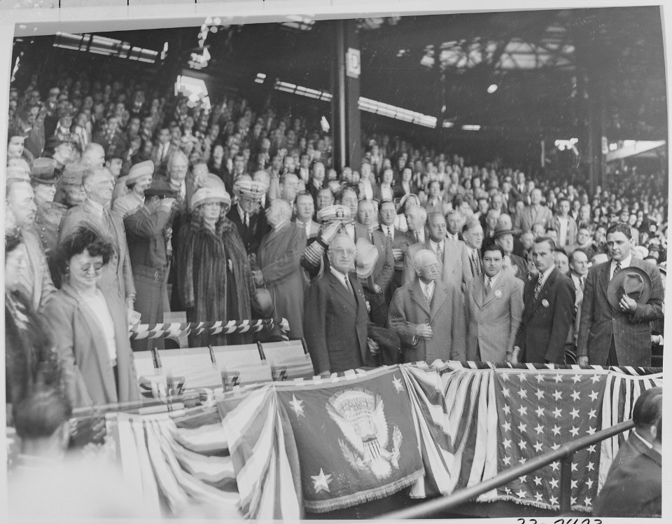 Photograph of President Truman standing up in his box at Washington's Griffith Stadium, waiting to throw out the... - NARA - 199578