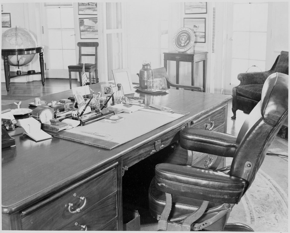 Photograph of President Truman's desk and chair in the Oval Office of the White House. - NARA - 199474