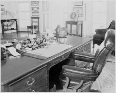 Photograph of President Truman's desk and chair in the Oval Office of the White House. - NARA - 199474