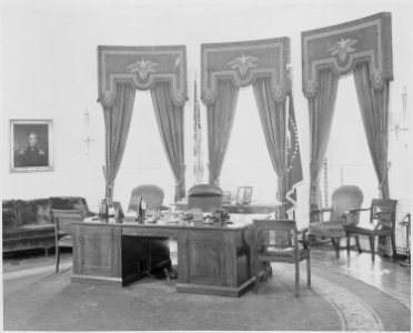 Photograph of the President's desk and other furnishings in the Oval Office of the White House. - NARA - 199475