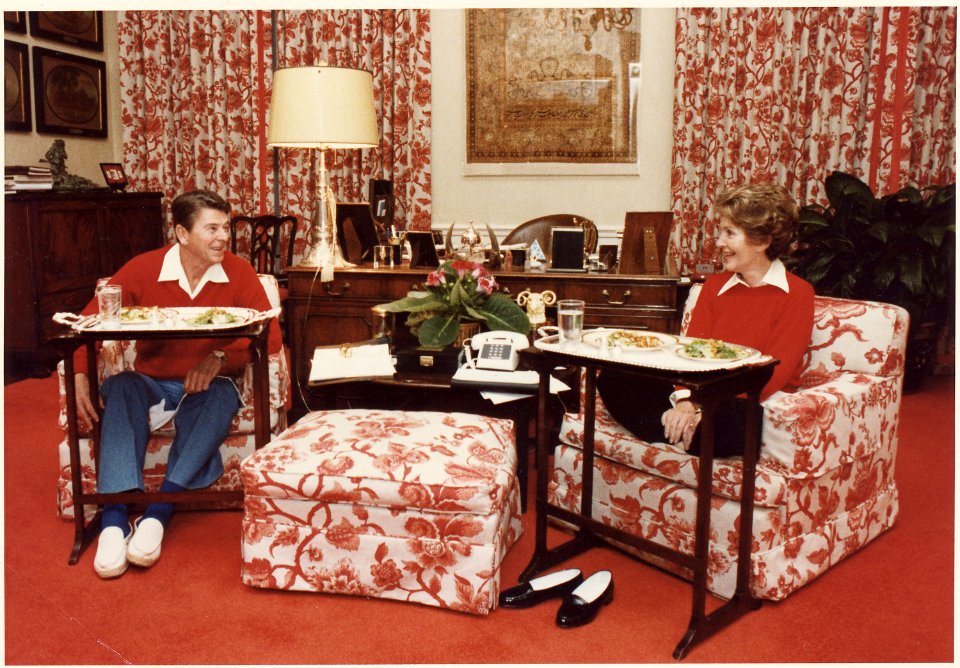Photograph of The Reagans eating on TV trays in the White House residence - NARA - 198525
