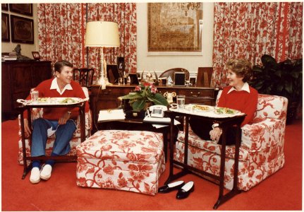 Photograph of The Reagans eating on TV trays in the White House residence - NARA - 198525