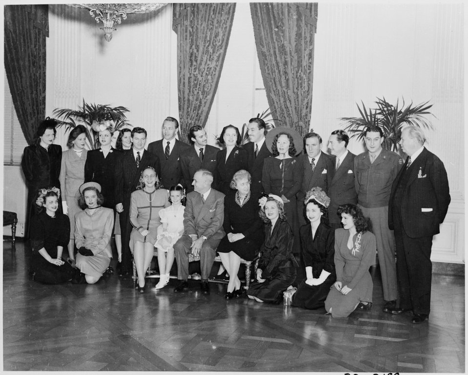 Photograph of movie stars posing with President Truman and his family at the White House, (front row, left to right)... - NARA - 199343