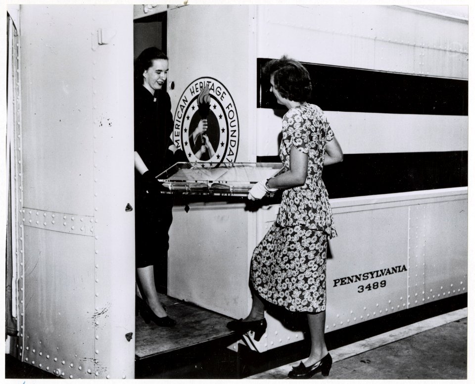 Photograph of National Archives Employees Peggy Mangum and Florence Nichol Loading the Log of the Frigate Constitution onto the Freedom Train (18463908653)