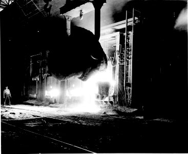 Photograph of a Vat of Molten Pig Iron Being Poured into an Open Hearth Furnace at the Jones and Laughlin Steel Company, Pittsburgh, Pennsy - NARA - 535922 (high contrast)