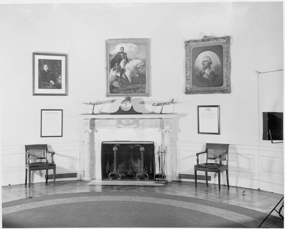 Photograph of the fireplace in the Oval Office at the White House, with a portrait of Simon Bolivar hanging over the... - NARA - 199471