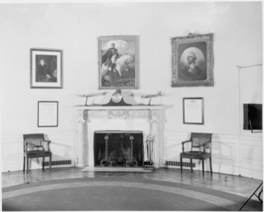Photograph of the fireplace in the Oval Office at the White House, with a portrait of Simon Bolivar hanging over the... - NARA - 199471