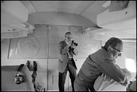 Photographer takes advantage of a photo opportunity aboard a flight - NARA - 194464