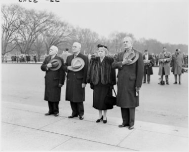 Photograph of the President and Mrs. Truman with other dignitaries, standing at attention during ceremonies at the... - NARA - 200182