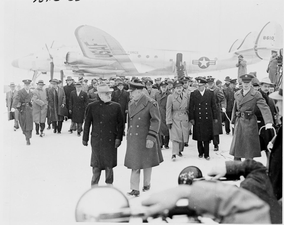 Photograph of President Truman and General Dwight D. Eisenhower walking away from the General's airplane on the snowy... - NARA - 200265