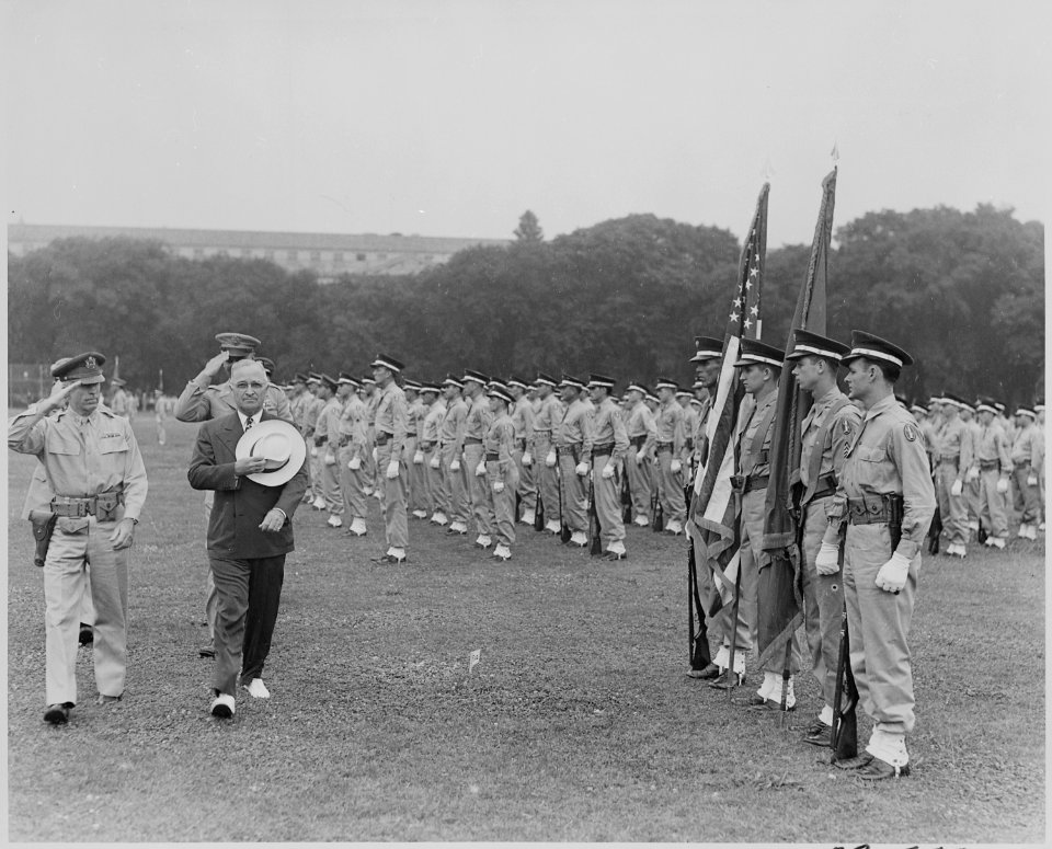 Photograph of President Truman and military officers saluting as they walk past the color guard during the... - NARA - 199385