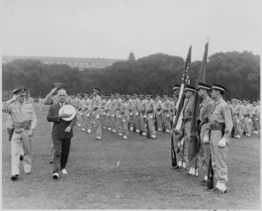 Photograph of President Truman and military officers saluting as they walk past the color guard during the... - NARA - 199385
