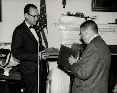 Photograph of Dr. James B. Rhoads Presenting Book of Tributes to Dr. Grover at His Retirement Party, 1965