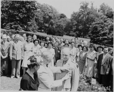 Photograph of President Truman decorating General Dwight D. Eisenhower with the Distinguished Service Medal, as Mrs.... - NARA - 199119