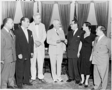 Photograph of President Truman in the Oval Office, receiving a gold membership card in the American Guild of Variety... - NARA - 200172