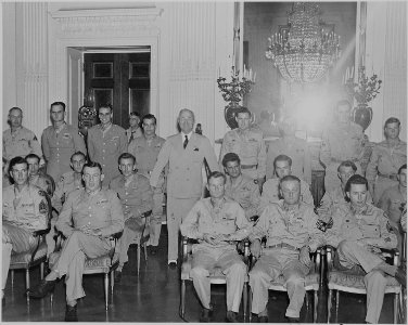 Photograph of President Truman posing with some of the twenty-eight recipients of the Medal of Honor who were... - NARA - 199193 photo