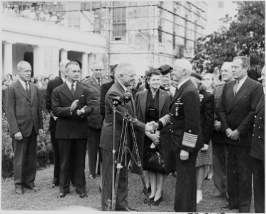 Photograph of President Truman shaking hands with Admiral Chester Nimitz after decorating him in the Rose Garden of... - NARA - 199223