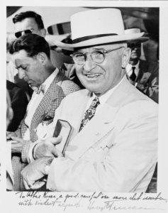 Photograph of President Truman smiling and checking his watch upon arrival in Miami (with an inscription from the... - NARA - 200165 photo