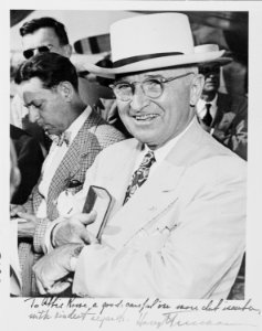 Photograph of President Truman smiling and checking his watch upon arrival in Miami (with an inscription from the... - NARA - 200165