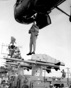 Piasecki HUP Retriever delivers man to USS Boston (CAG-1), in 1957 (L45-33.02.05)