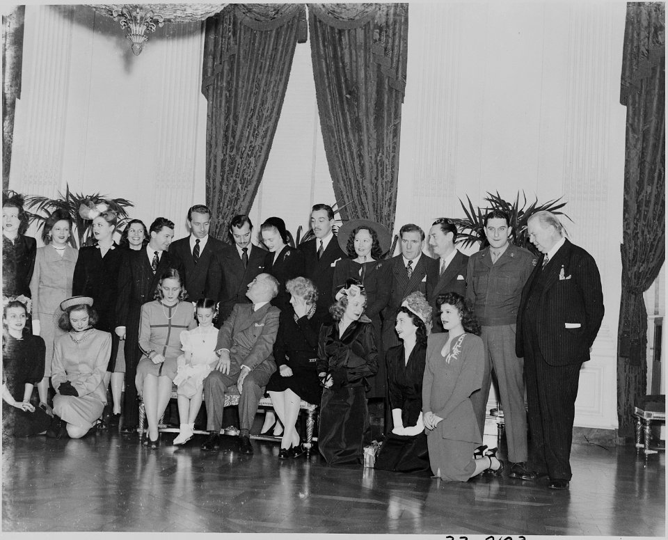 Photograph of Hollywood celebrities posing with the Truman family in the East Room of the White House, (front row... - NARA - 199258