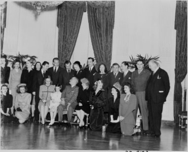 Photograph of Hollywood celebrities posing with the Truman family in the East Room of the White House, (front row... - NARA - 199258
