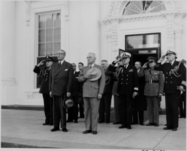 Photograph of President Truman and President Juan Antonio Rios of Chile, with others, standing at attention outside... - NARA - 199242