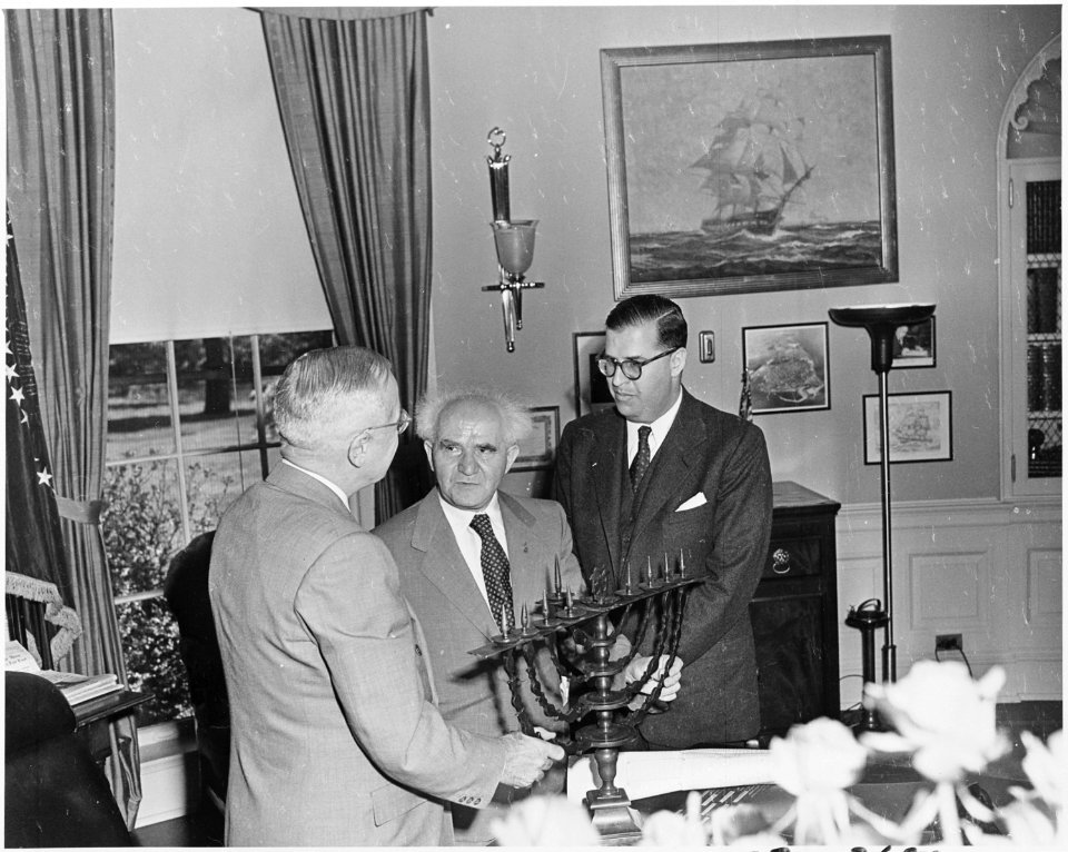 Photograph of President Truman in the Oval Office, evidently receiving a Menorah as a gift from the Prime Minister of... - NARA - 200318