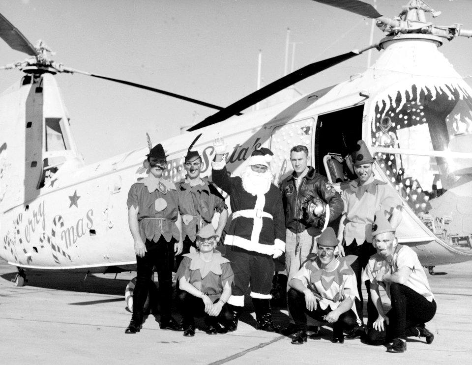 Piasecki HUP Christmas helicopter with Santa Claus and elves at Naval Air Station Oakland, 23 December 1956 (K-21585)