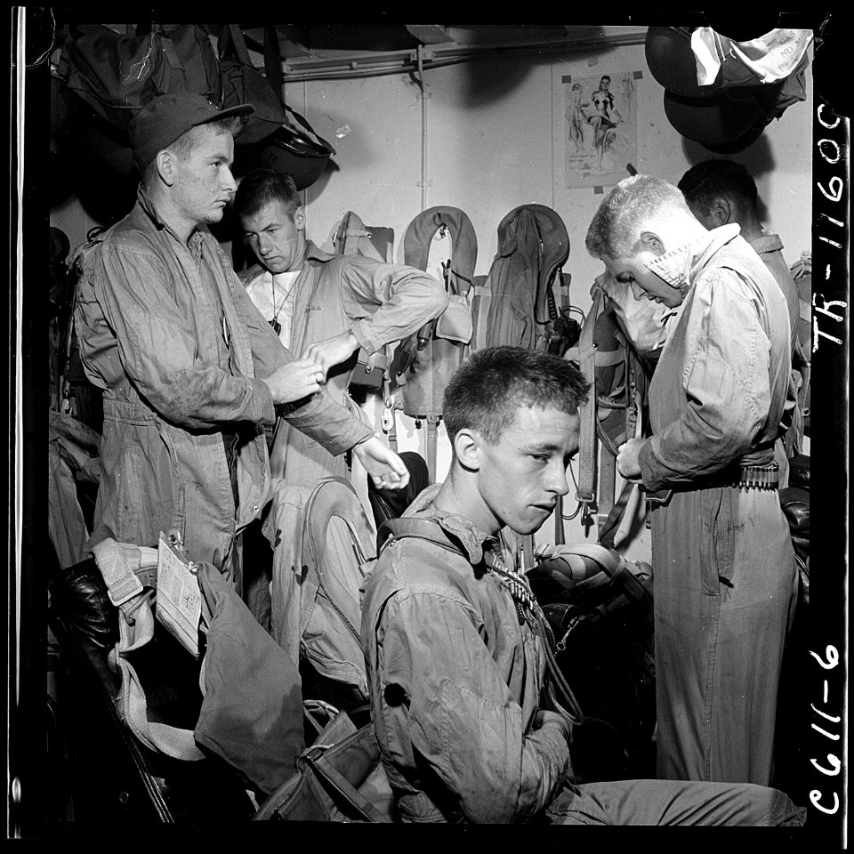 Pilots slip into flight gear aboard USS Ticonderoga (CVA-14) for strike on Manila, P.I. - NARA - 520758