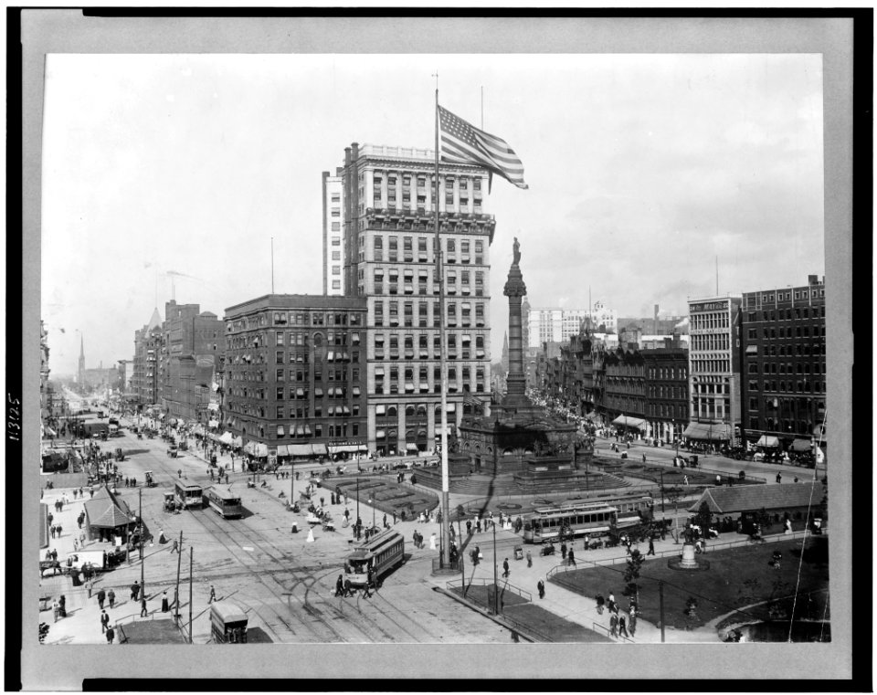 Public square showing monument, department stores, banks, trolley cars, pedestrians in Cleveland, Ohio LCCN95507544