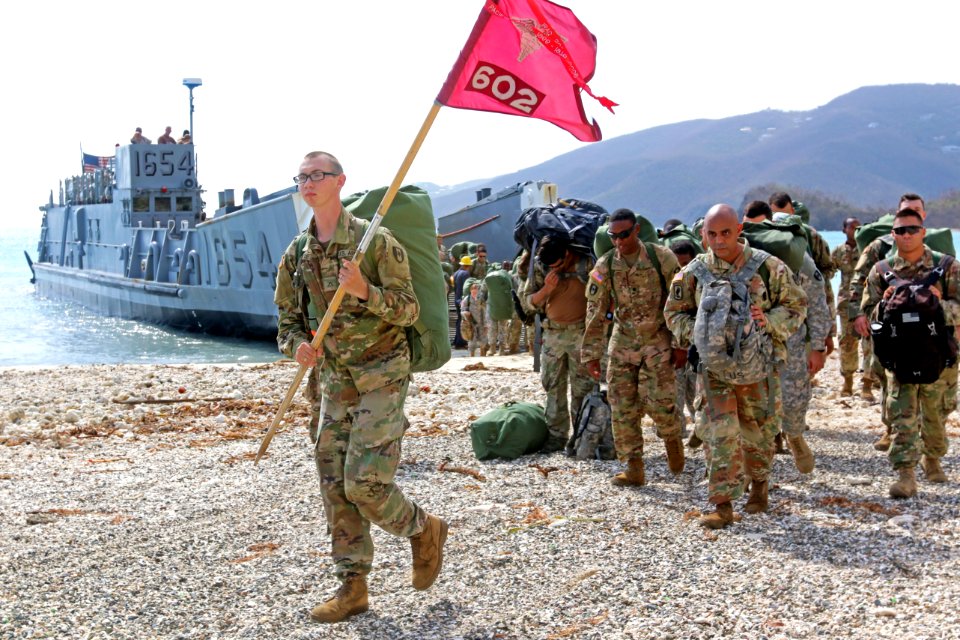 Pvt. Douglas Dodge leads the 602nd ASMC off the landing craft, utility. (37314723451)