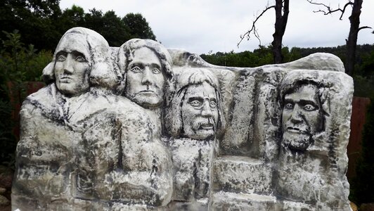 Stone statues the faces of four