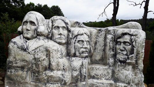 Stone statues the faces of four photo