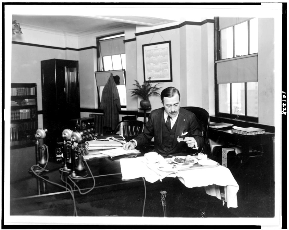 R.G. Cholmeley-Jones, Director of the War Risk Bureau, eating lunch at his desk LCCN90713038
