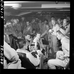 R. Adm. Calvin T. Durgin joins a group of pilots in the ready room of the USS Tulagi (CVE72) after successful strike... - NARA - 520674