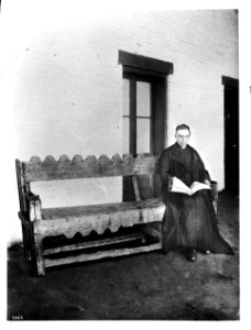 Plaza Church priest Reverend Joachim Adam, sitting on a bench, Los Angeles, ca.1890-1900 (CHS-3866) photo