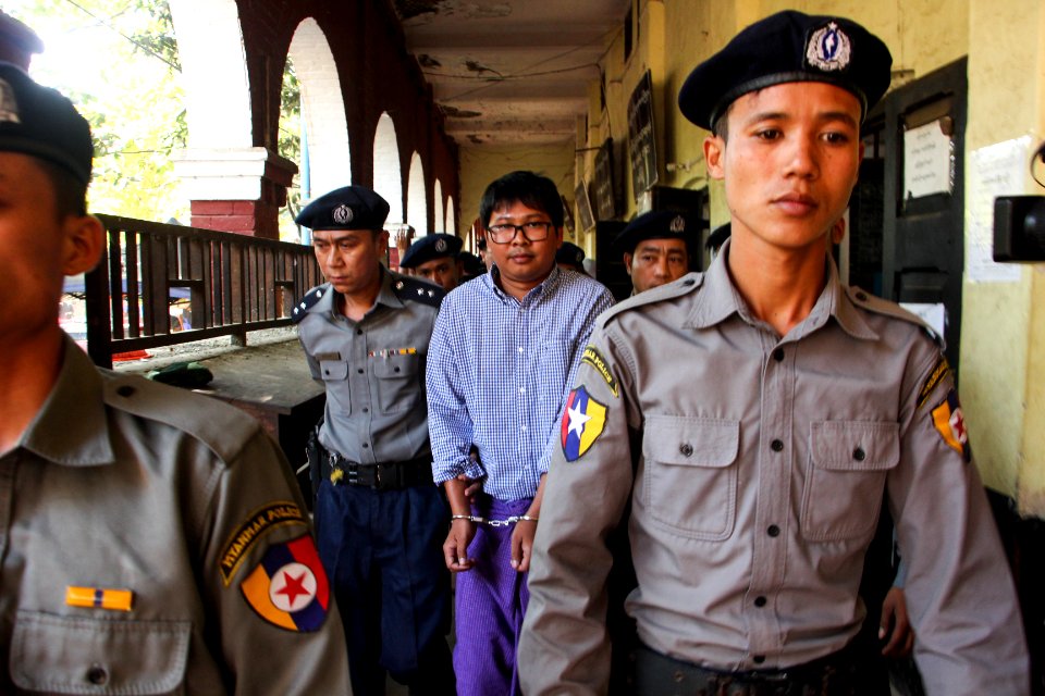 Police escort detained Reuters journalist Wa Lone
