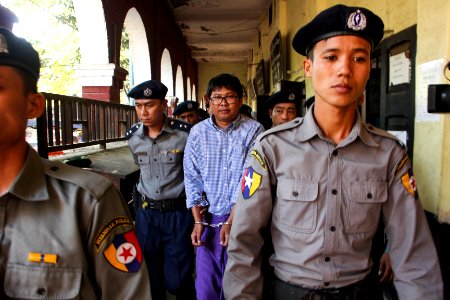 Police escort detained Reuters journalist Wa Lone